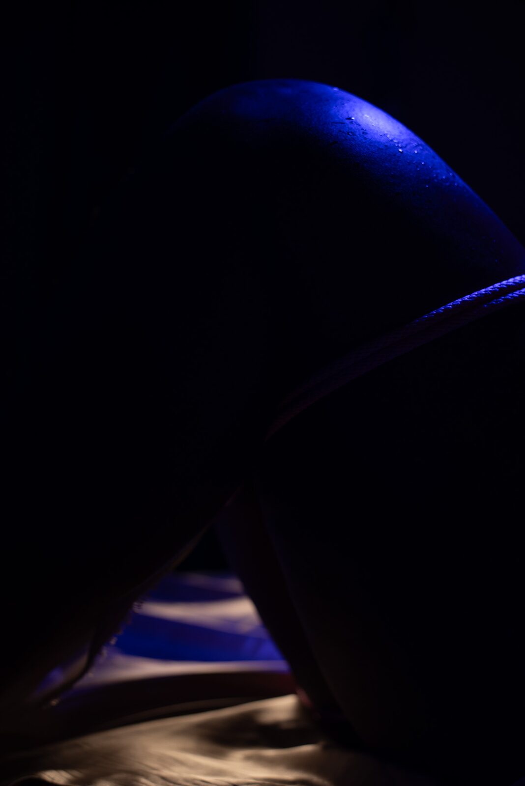 Low-key silhouette, body curve in deep blue light