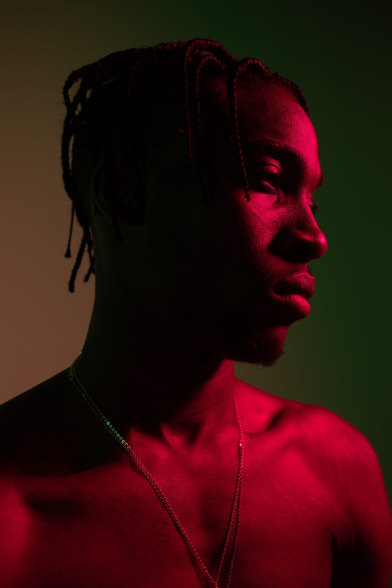 Mood still: a figure in warm red light.