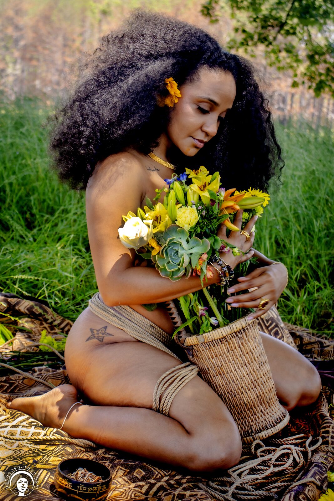 Two figures suspended over a bed of yellow flowers in tall grass.